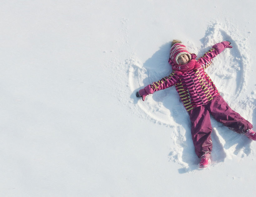 Kid doing a snowangel. 